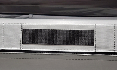 A gazebo handle strap mounted on the inside of a hot tub cover hinge.