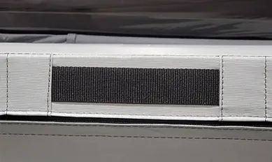 A gazebo handle strap mounted on the inside of a hot tub cover hinge.