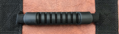 Close-up of a ribbed rubber handgrip fitted over a hot tub cover handle strap.