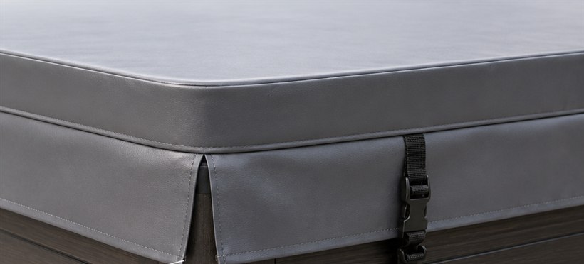 Close-up of a hot tub cover corner showing the split-corner skirt, where two skirt panels meet at the corner instead of wrapping around it.