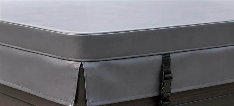 Close-up of a hot tub cover corner showing the split-corner skirt, where two skirt panels meet at the corner instead of wrapping around it.